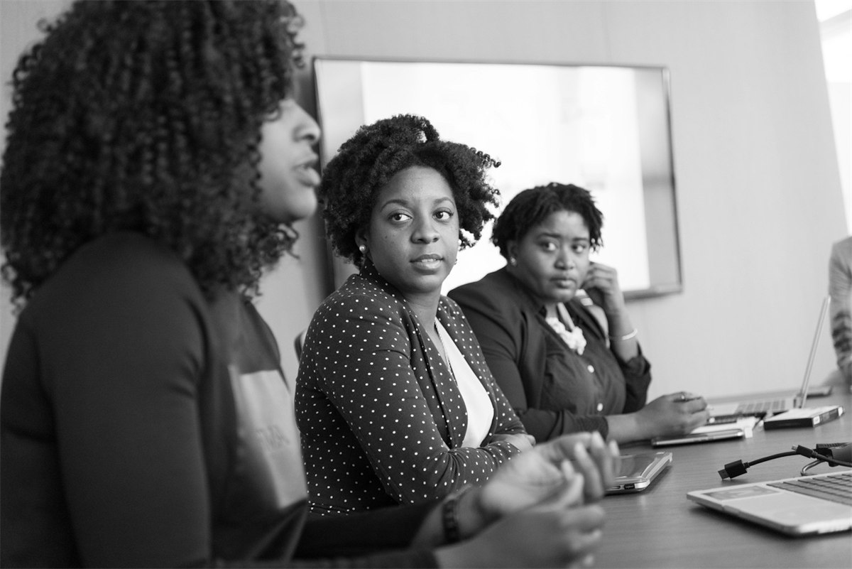 assets/mukunge-people/woc-grayscale-meeting.jpg